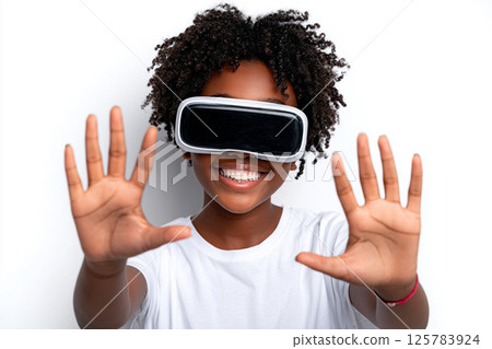 Virtual Joy. Smiling child with curly hair enjoying virtual reality. 125783924