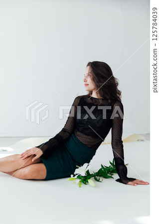 Portrait of a beautiful slender fashionable woman in a black dress Portrait of a beautiful slender fashionable woman in a black dress 125784039