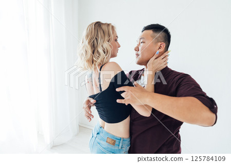 Man and woman dancing together to music 125784109