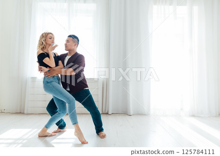 Man and woman dancing together to music Man and woman dancing together to music 125784111