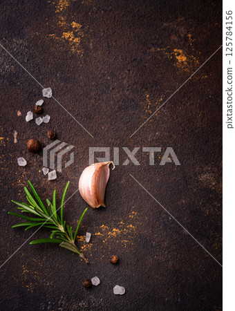 Rosemary, garlic, salt and pepper. 125784156