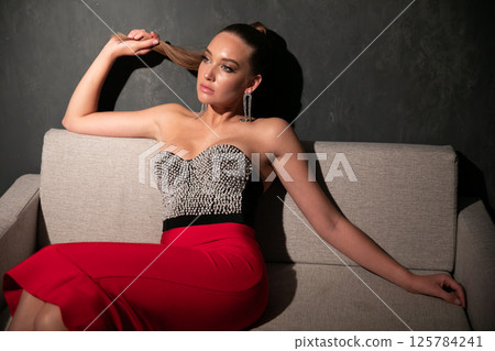 Portrait of a beautiful woman in an evening dress Portrait of a beautiful woman in an evening dress 125784241