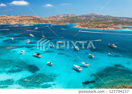 Aerial view of luxury yachts and boats on blue sea, island 125784257