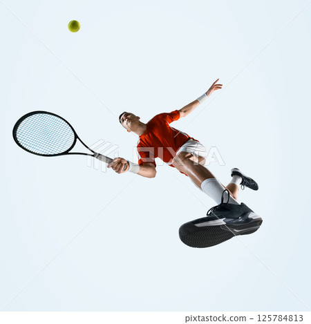 Low angle view of man, tennis player in motion racket, showing power agility and determination against white studio background. 125784813