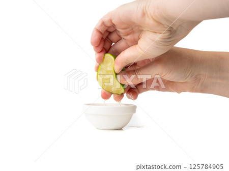 Squeezed lime isolated, squeezed out half green lemon on white background, burnout symbol Squeezed lime isolated, squeezed out half green lemon on white background, burnout symbol 125784905