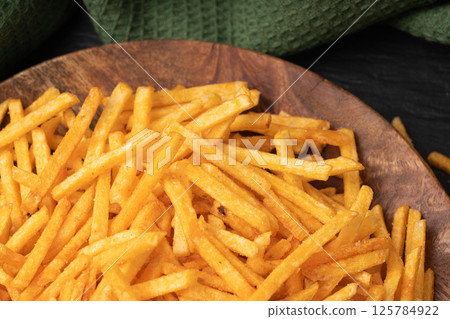 Fried chips sticks, finger potato chips, golden shoestring fries pile, French fries Fried chips sticks, finger potato chips, golden shoestring fries pile, French fries 125784922