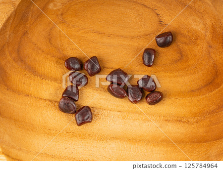 Dried tamarind seeds isolated, Tamarindus indica beans on a white background, medicine ingredient 125784964