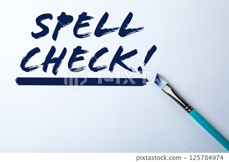 Spell Check. Text and paint brush on white background 125784974