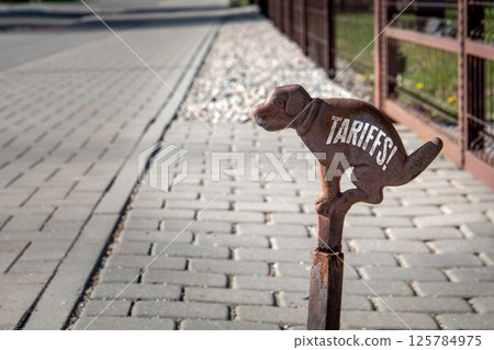 Tariffs Concept. Dog Shaped Sign on Paved Street 125784975