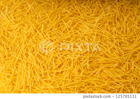 Raw vermicelli textured background, gold soup pasta pattern, small homemade noodles mock up 125785131