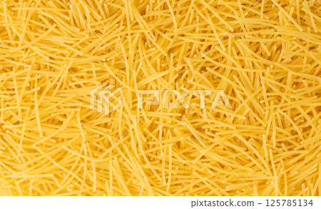 Raw vermicelli textured background, gold soup pasta pattern, small homemade noodles mock up Raw vermicelli textured background, gold soup pasta pattern, small homemade noodles mock up 125785134