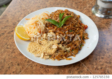 Pad thai or phad tha asian noodles closeup. Chinese rice pasta, phat thai with meat, noodles 125785150
