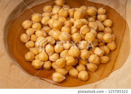 Soaked chickpeas, chick pea in water, swollen wet Cicer arietinum fruits, garbanzo beans cooking Soaked chickpeas, chick pea in water, swollen wet Cicer arietinum fruits, garbanzo beans cooking 125785322