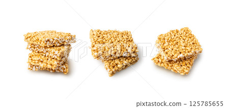 Puffed rice bar isolated, sweet wheat kozinaki, puff cereal block pieces, sugar crispy wheat bar, healthy popped dessert Puffed rice bar isolated, sweet wheat kozinaki, puff cereal block pieces, sugar crispy wheat bar, healthy popped dessert 125785655