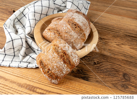 Brown rye bun, square gluten free bread, whole grain healthy breakfast bread Brown rye bun, square gluten free bread, whole grain healthy breakfast bread 125785688