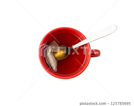Herbal tea sachet in cup, hot water with chamomile and Hypericum or St. John's wort teabag 125785695