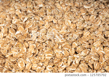 Spelt flakes isolated, dry raw rolled flat oat grains, wheat, oatmeal or bran, barley rye cereals Spelt flakes isolated, dry raw rolled flat oat grains, wheat, oatmeal or bran, barley rye cereals 125785702