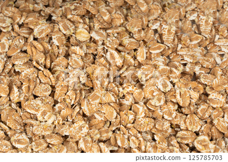 Spelt flakes isolated, dry raw rolled flat oat grains, wheat, oatmeal or bran, barley rye cereals 125785703