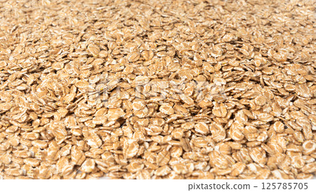 Spelt flakes isolated, dry raw rolled flat oat grains, wheat, oatmeal or bran, barley rye cereals 125785705