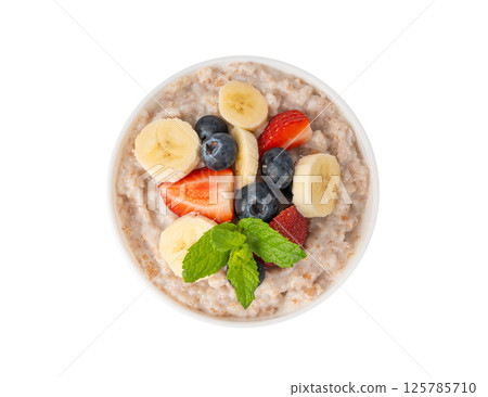 Cooked spelt in bowl isolated. Oatmeal milk porridge with fruits and berries 125785710