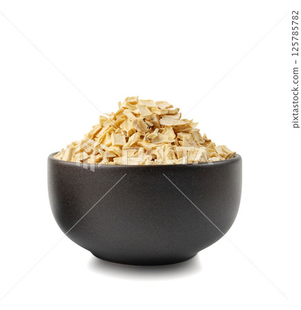 Dry parsley root, dried diced celery cubes, scattered small liquorice pileces, dry vegetable 125785782