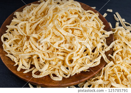 Passatelli spatzle pasta in bowl, raw spaetzle noodles, dry homemade german macaroni Passatelli spatzle pasta in bowl, raw spaetzle noodles, dry homemade german macaroni 125785791