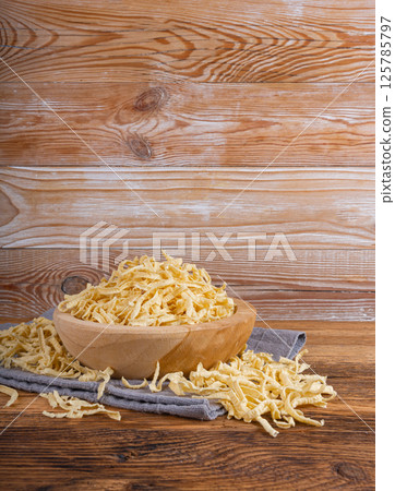 Passatelli spatzle pasta in bowl, raw spaetzle noodles, dry homemade german macaroni Passatelli spatzle pasta in bowl, raw spaetzle noodles, dry homemade german macaroni 125785797