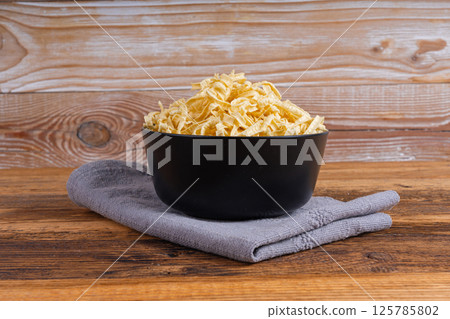 Passatelli spatzle pasta in bowl, raw spaetzle noodles, dry homemade german macaroni Passatelli spatzle pasta in bowl, raw spaetzle noodles, dry homemade german macaroni 125785802