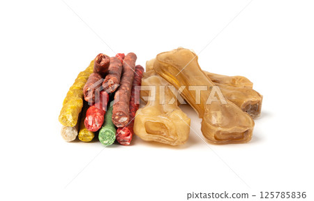 Rawhide chew sticks for dogs, colorful collagen dog food, pressed dry kibble, dental care treats 125785836