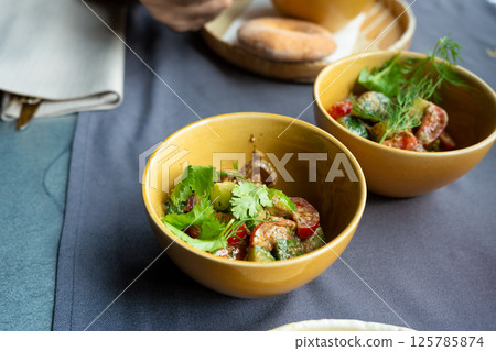 Georgian salad of fresh vegetables with nut dressing. Traditional glekhurad salat Georgian salad of fresh vegetables with nut dressing. Traditional glekhurad salat 125785874