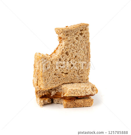 Bitten dried pate sandwich isolated, low-quality food leftovers, bad quality toast bread lunch 125785888