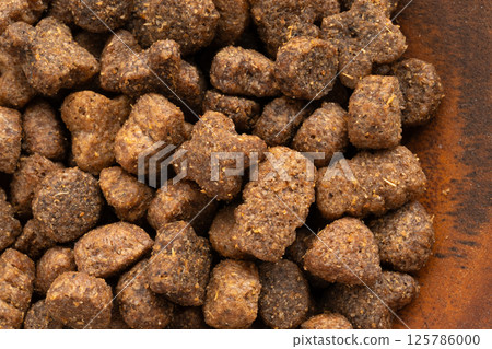 Dry pet food macro pieces, cat kibble closeup, dog pellets, small protein croquettes detailed 125786000