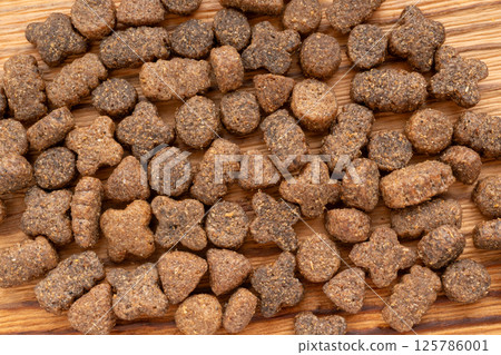 Dry pet food macro pieces, cat kibble closeup, dog pellets, small protein croquettes detailed Dry pet food macro pieces, cat kibble closeup, dog pellets, small protein croquettes detailed 125786001