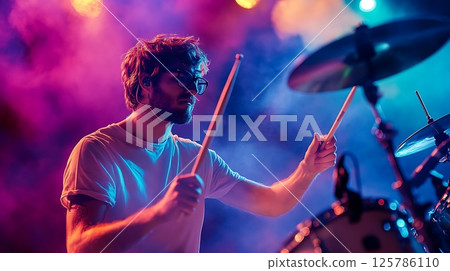 Drummer Immersed in Performance Amidst Vibrant Concert Lights Drummer Immersed in Performance Amidst Vibrant Concert Lights 125786110