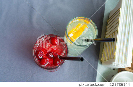 Cold lingonberry drink on restaurant table. Iced cowberry tea, refreshing cranberry cocktail Cold lingonberry drink on restaurant table. Iced cowberry tea, refreshing cranberry cocktail 125786144
