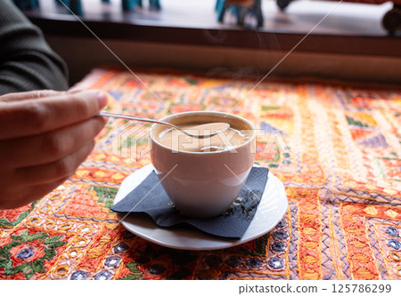 Masala chai an Indian restaurant, spiced milk tea, traditional cardamom hot drink with spices Masala chai an Indian restaurant, spiced milk tea, traditional cardamom hot drink with spices 125786299