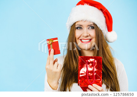 Happy Christmas woman holds red gift box 125786650