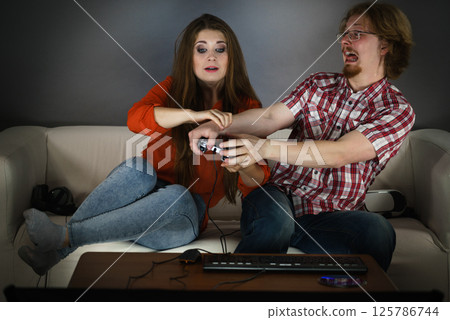 Gamer couple playing games Gamer couple playing games 125786744