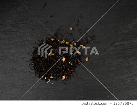 Flavored Black Tea Leaves Pile Texture, High Quality Black Tea Pile with Fruits and Flowers, Dry Tea Leaves 125786873
