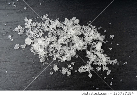 Dead sea salt pile, white crystals for body spa, sodium chloride similar to crushed ice, spa scrub 125787194
