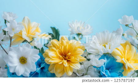 A gorgeous flower wall covered with colorful blue and yellow flowers 125787197