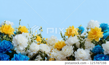 A gorgeous flower wall covered with colorful blue and yellow flowers 125787198