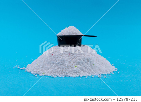 Detergent powder pile. Laundry washing soap granules, small white texture of oxygen bleach Detergent powder pile. Laundry washing soap granules, small white texture of oxygen bleach 125787213