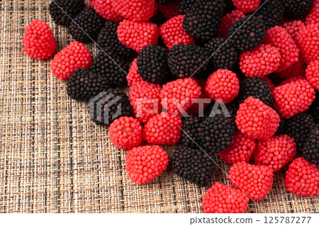 Gummy berries texture background, chewy raspberries close up, jelly blackberries pattern Gummy berries texture background, chewy raspberries close up, jelly blackberries pattern 125787277