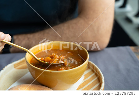 Spicy kharcho or harcho soup, traditional Georgian chowder. Creamy kharcho broth 125787295