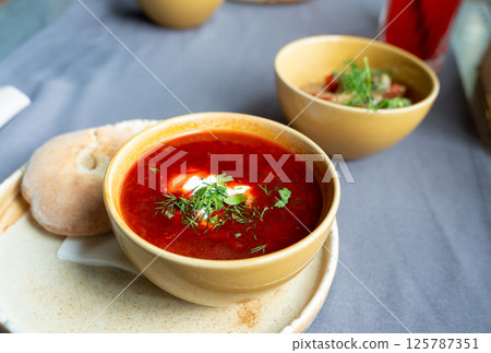 Borscht or borsch in bowl, Ukrainian beetroot soup. Red chowder thick borscht with sour cream 125787351