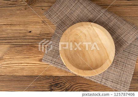 Empty wood bowl on table, plate on wooden table and tablecloth, light rustic dish mockup 125787406