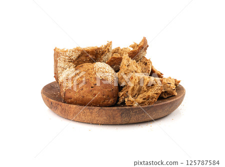 Broken wheat brown bread pieces isolated, fitness pumpkin carrot buns with seeds, cereal bread Broken wheat brown bread pieces isolated, fitness pumpkin carrot buns with seeds, cereal bread 125787584