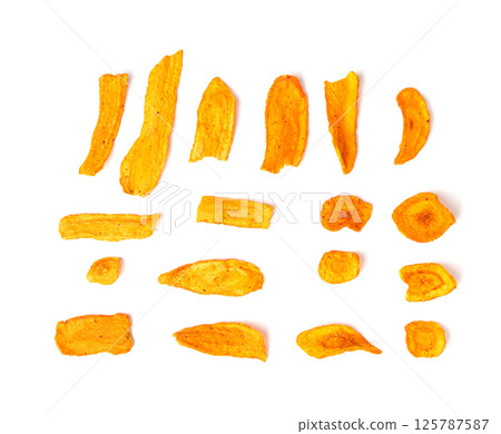 Dry carrot chips isolated, dried sliced red vegetable, healthy crispy snack flakes pile 125787587