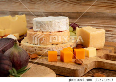 Cheese plate of color cheeses variety, yellow, white and blue cheese board, assorted dairy products 125787603